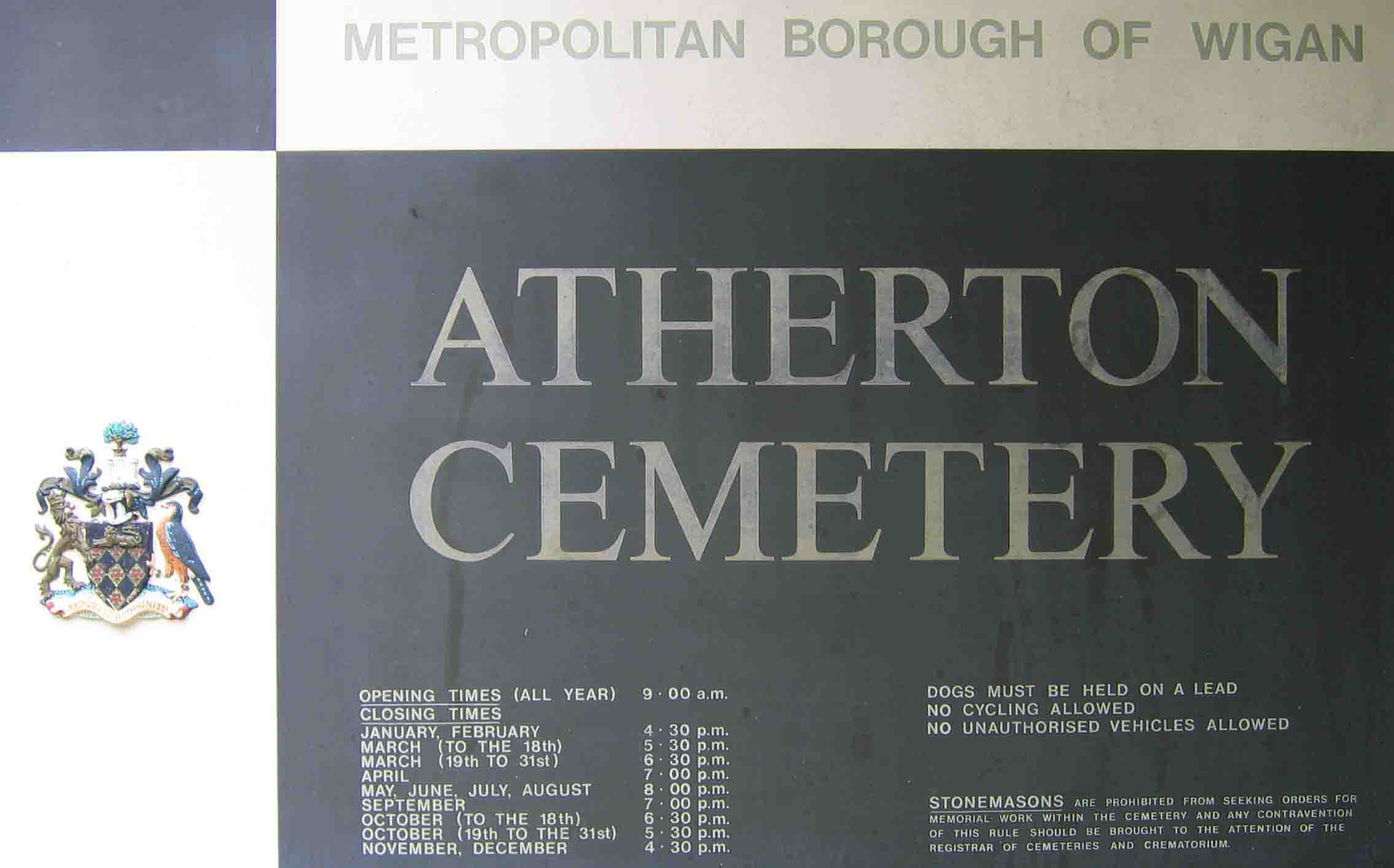 Sign at the cemetery entry giving opening hours, rules and regulations and a warning to stonemasons. Photo by Peter Wood July 2005