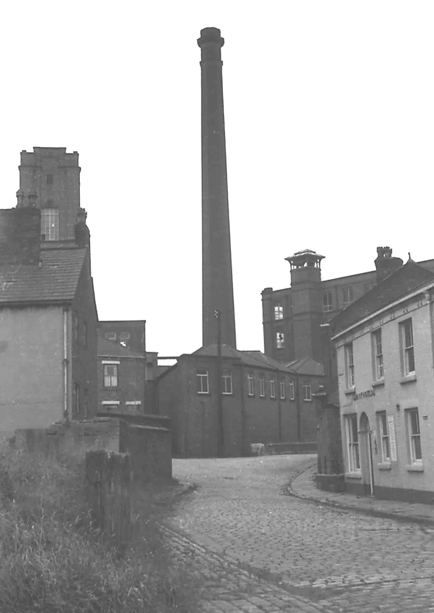 The chimney of Atherton Spinning Mills at the junction of The Valley and Bolton Old Road - the heart of old Chowbent. Photo by Peter Wood, 1963