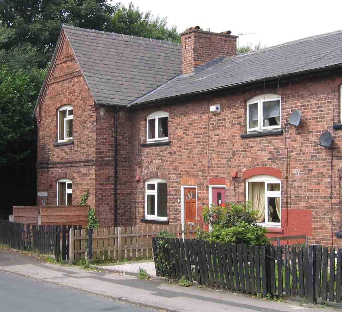 Houses at the south end of Lilford Street, where many of the Atherton Collieries men and their families lived. The trees in the background are growing on the embankment of the old railway. Photo by Peter Wood, May 2005