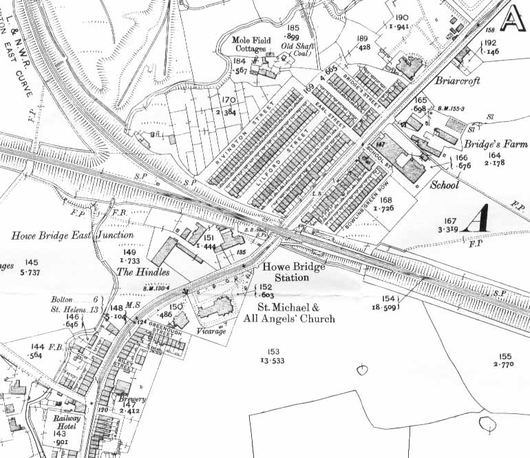 Map of Howe Bridge in 1908 from OS Sheet 94.15 Atherton SW (Godfrey Edition). Leigh Road crosses from NE to SW, and the railway, on its high embankment, from E to W. Howe Bridge model village is the grid of streets and buildings to the north of Howe Bridge Station. The road joining Leigh Road from the west, to the north of the Railway Hotel, is Lovers Lane. Map is about 0.56km across.