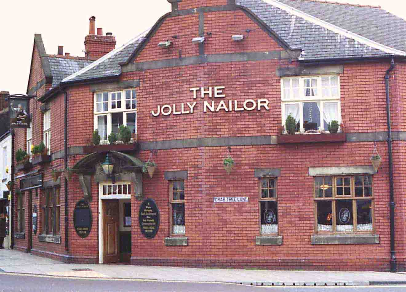 The Jolly Nailor, a last reminder of Atherton's nail trade. The modern inn sign shows a cobbler banging home a boot nail, no doubt a Chowbent sparrowbill. Photo by Peter Wood, 22 Dec 2003