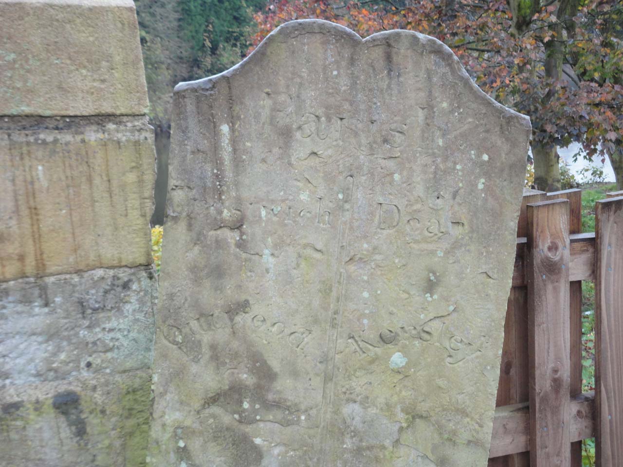 A boundary stone between the Parishes of Prestwich and Dean; stands by Ringley Old Bridge on the opposite bank of the river Irwell from the church of St Saviour