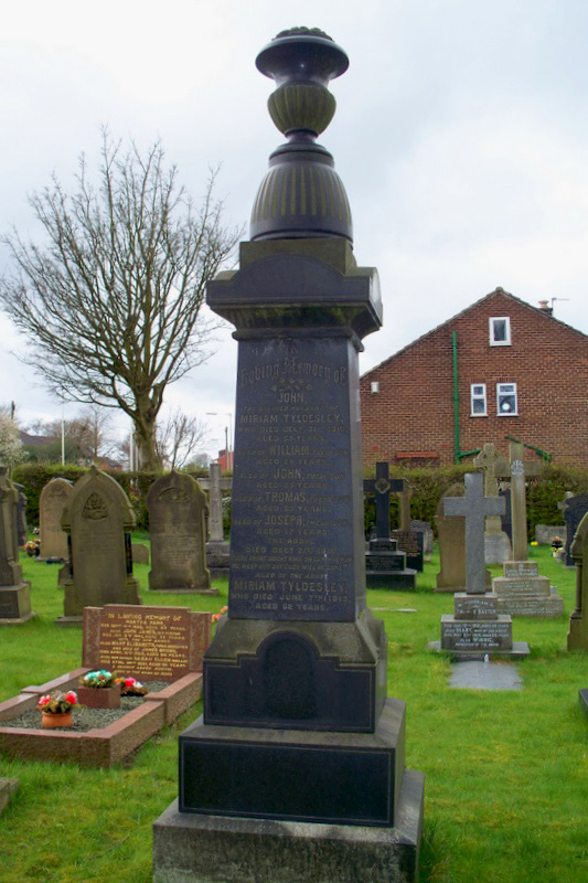 The Tyldesley family memorial. 45 victims of the 21 Dec 1910 Pretoria Pit disaster lie in St John's churchyard. Miriam Tyldesley lost her husband, four sons and her brothers James and Thomas Hurst, whose memorials are also in this churchyard