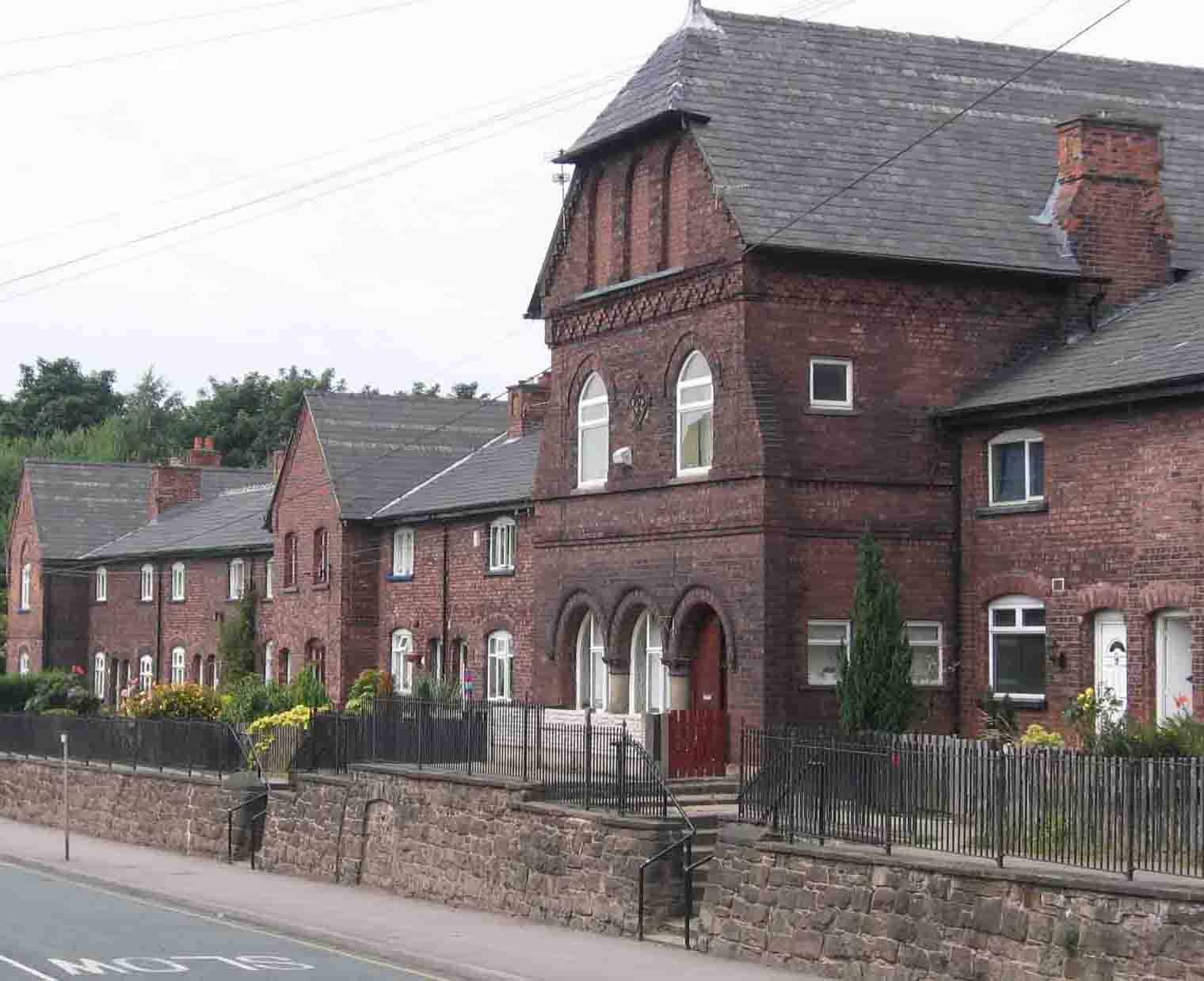 The influence of the Dutch architect is seen in The Promenade along Leigh Road. The large building was a communal bath-house for miners and their families, now a private residence. The trees in the background are growing on the embankment of the old railway. Photo by Peter Wood, May 2005